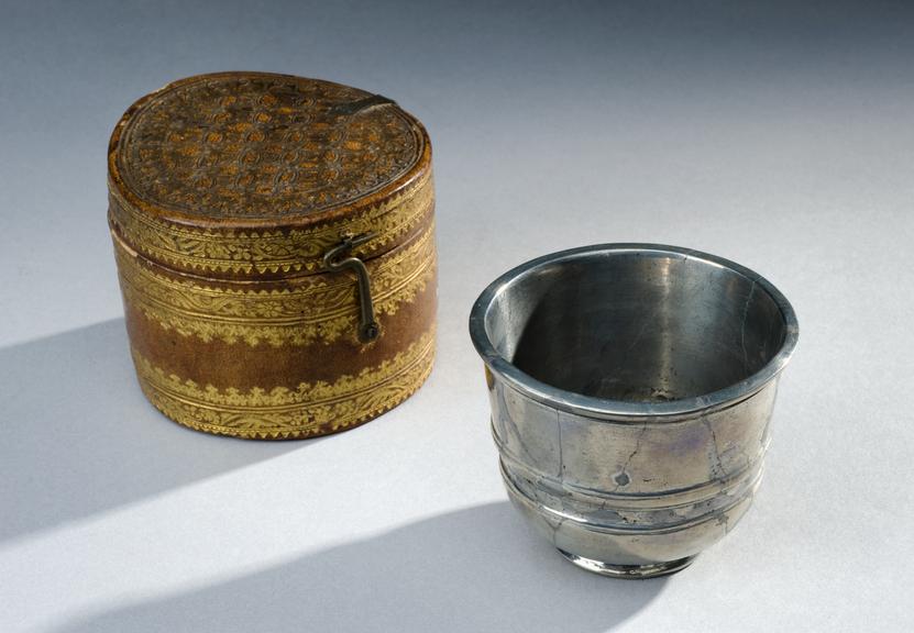 Antimony cup, in leather case, tooled with gold, 17th century