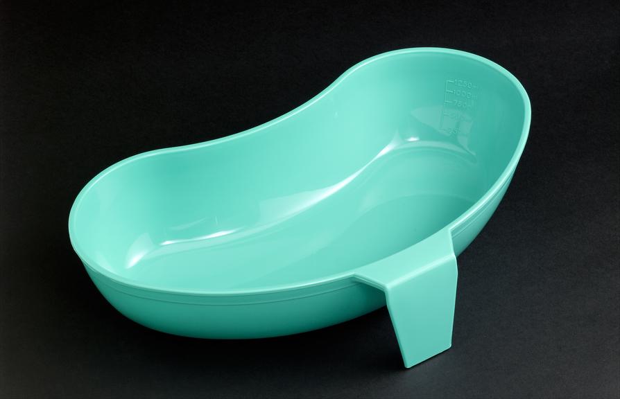 Green plastic vomit bowl with handle, England, 2005