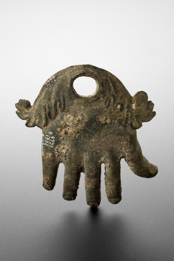 Bronze white hand with eye hole for suspension, Roman