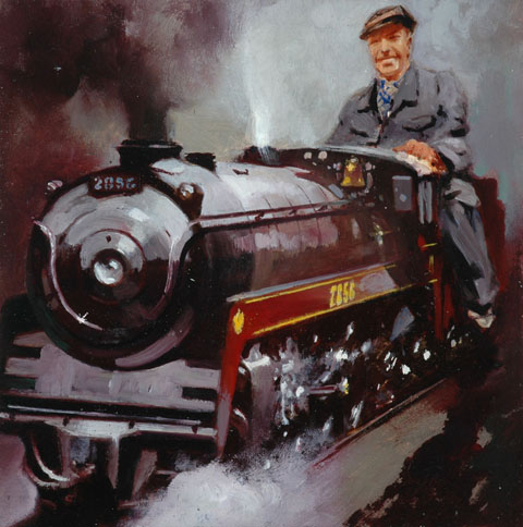 man driving a miniature steam locomotive