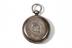Pocket watch, photographed from above on a white background.