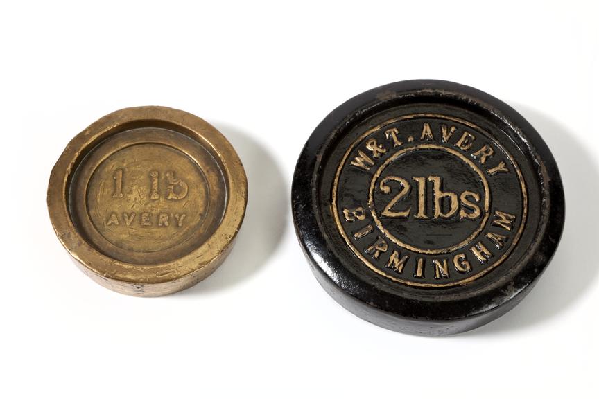 3/4 view of two metal weights by W. & T