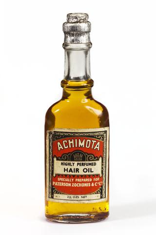 Achimota Highly Perfumed Hair Oil in a labeled glass bottle with a foil wrapped cork top