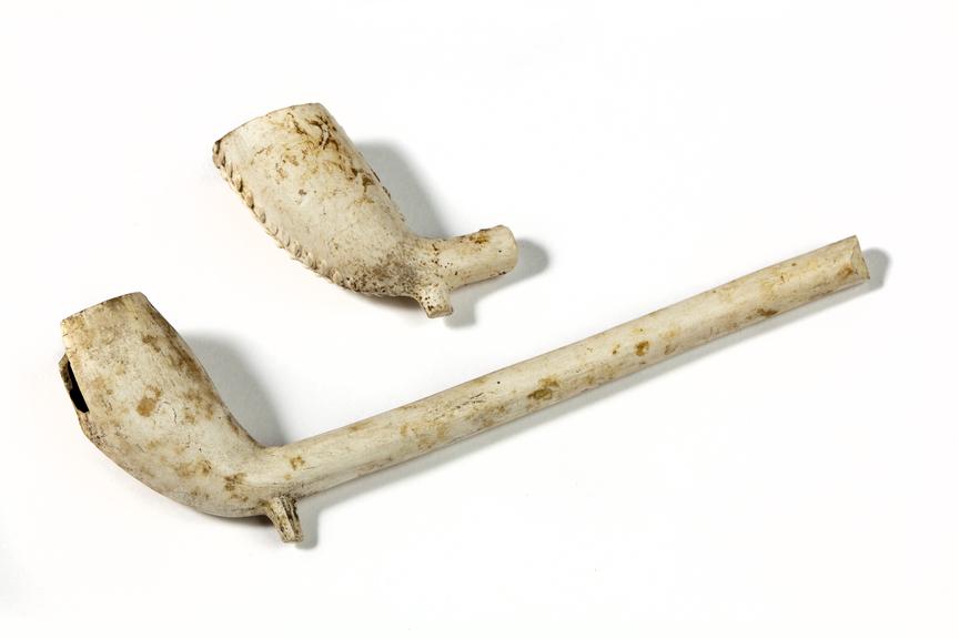 two incomplete clay tobacco pipes, c.1850.