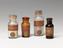 Four dyes in glass bottles with cork stoppers, 1800-1900