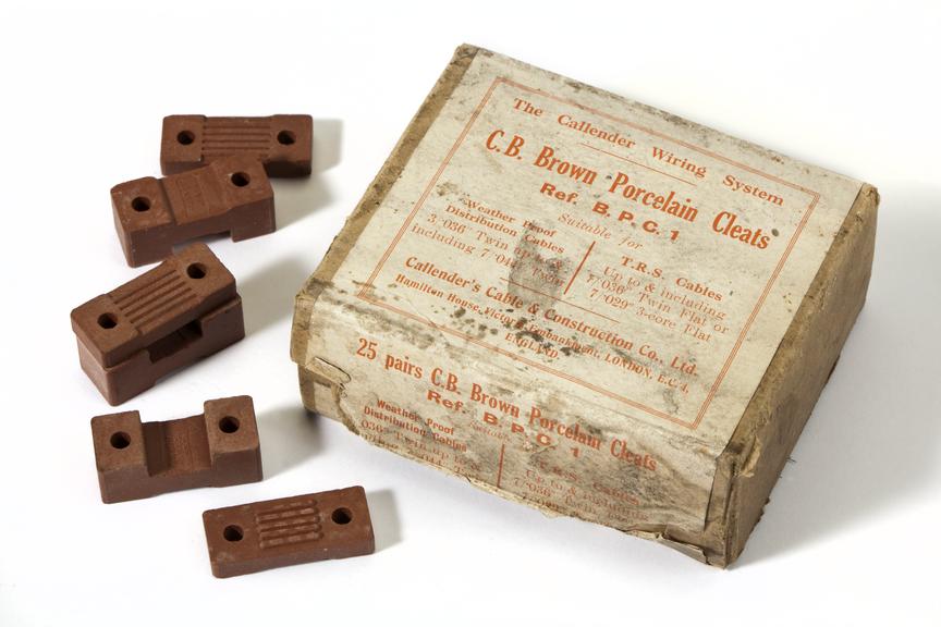 Box of C.B. Brown porcelain cleats, 25 pairs.