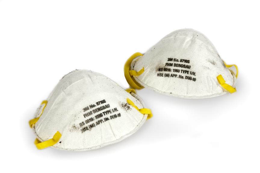 Two dust masks; white with yellow rubber strap.