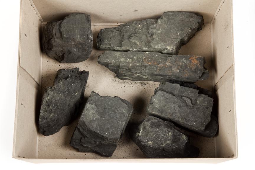 Coal sample in a cardboard box photographed from above on a