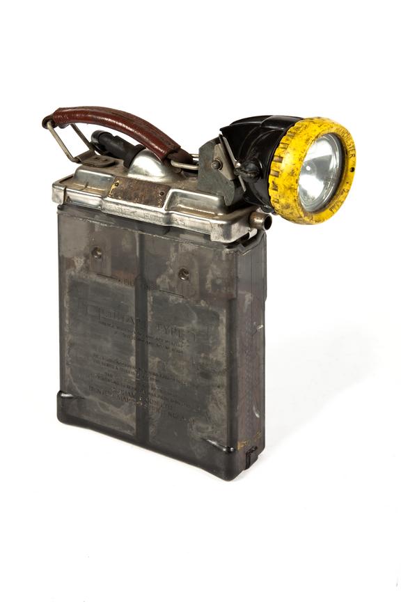 Miner's electric cap lamp and battery.