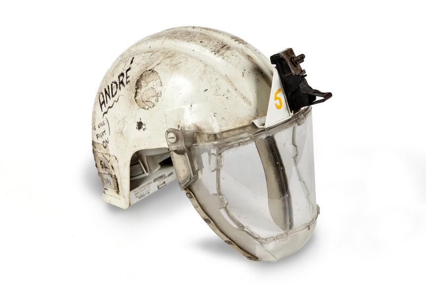 Plastic safety helmet with visor, 'Andre' written in marker