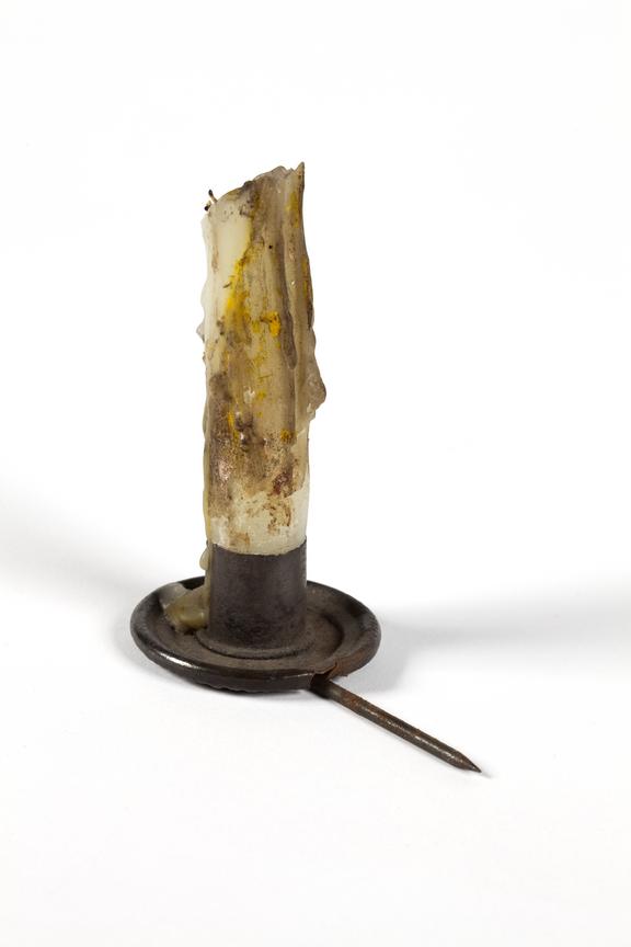 Candle holder with tallow candle stub, coal mining use.