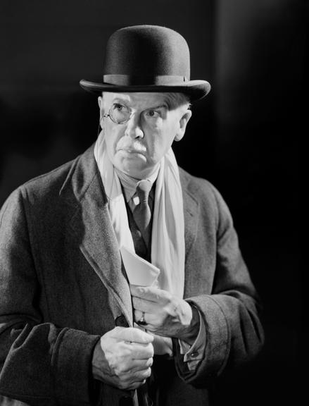 Man wearing a monocle and bowler hat