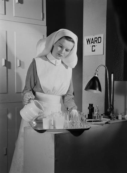 Nurse pouring drinks