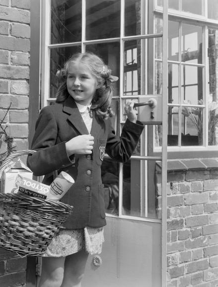 Girl carrying a shopping basket