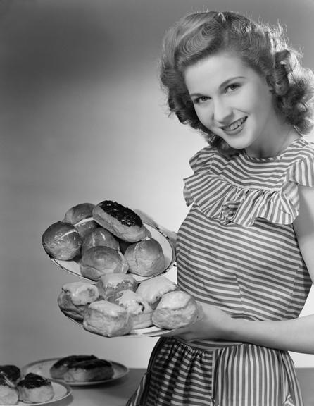 Woman holding plates of cakes