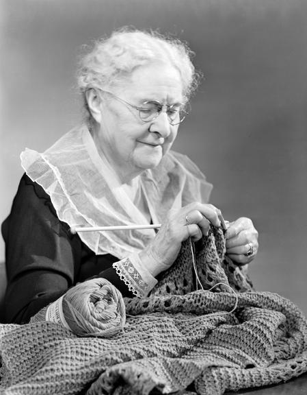 Elderly woman knitting
