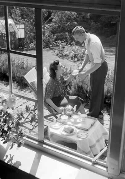 Couple taking afternoon tea in the garden