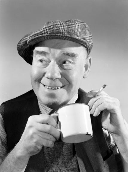 Portrait of a man smoking and drinking from a mug