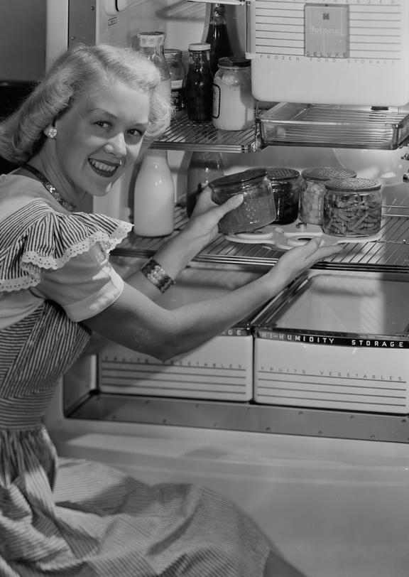 Woman taking food from a fridge
    A photograph of a woman taking