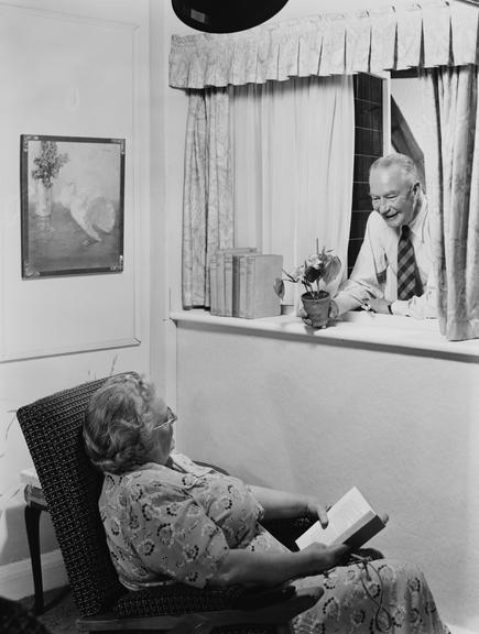 Elderly couple talking through a window