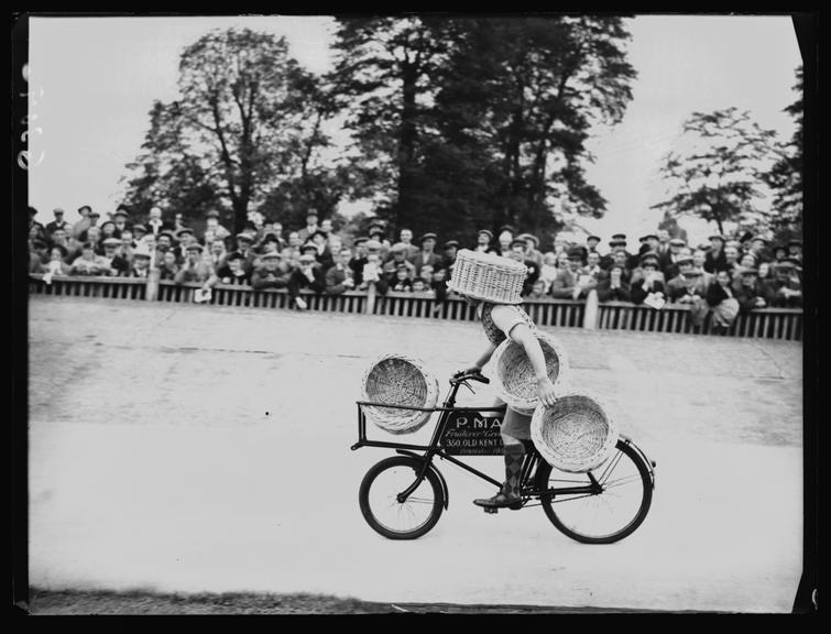 Basket-carrying cyclist at charity sports day