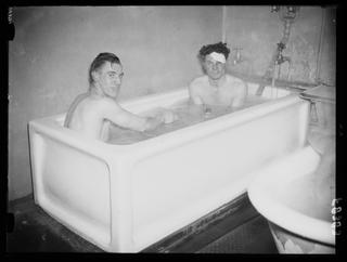 Two footballers share a bath