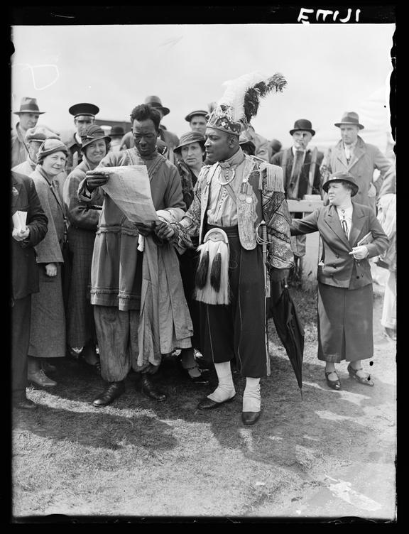 Tipsters at Epsom
    A photograph of two exotically-dressed men