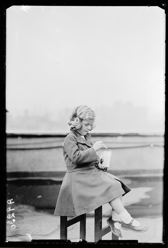 Little girl with a packet of cigarettes
    A photograph of a