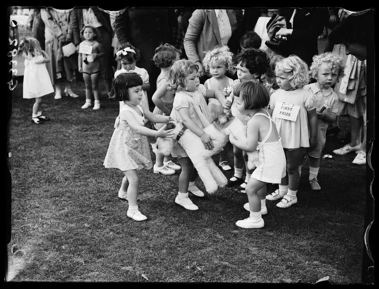 Children at a carnival
    A photograph of three little girls