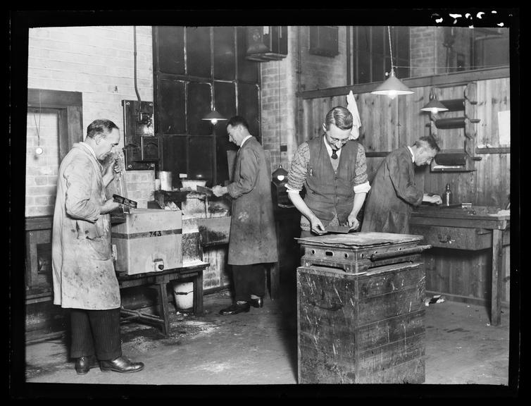 The process department
    A photograph of men in overalls working