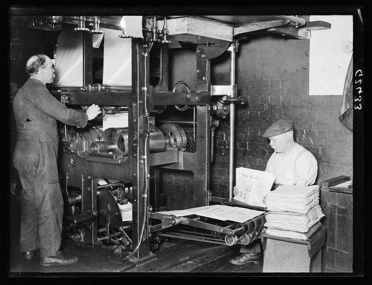 The Daily Herald machine room 
    A photograph of workers in the