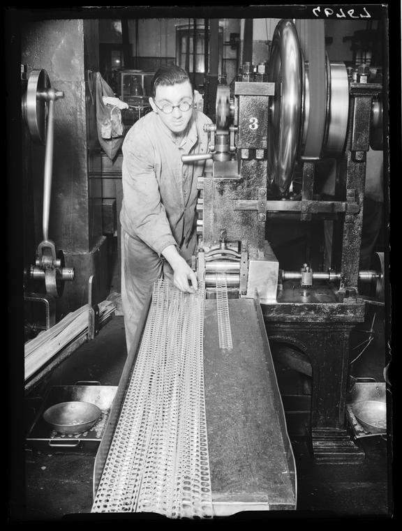 Making coins at the Royal Mint
    A photograph of a worker at the