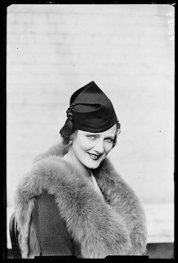 'Woman displaying latest hat fashion'
    A photograph of a model