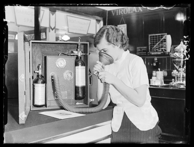 Woman demonstrating portable pain relief apparatus
    A