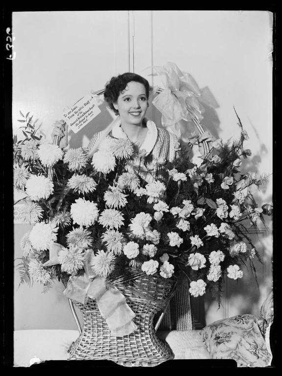 'Jessie Matthews with a floral gift'
    A photograph of Jessie