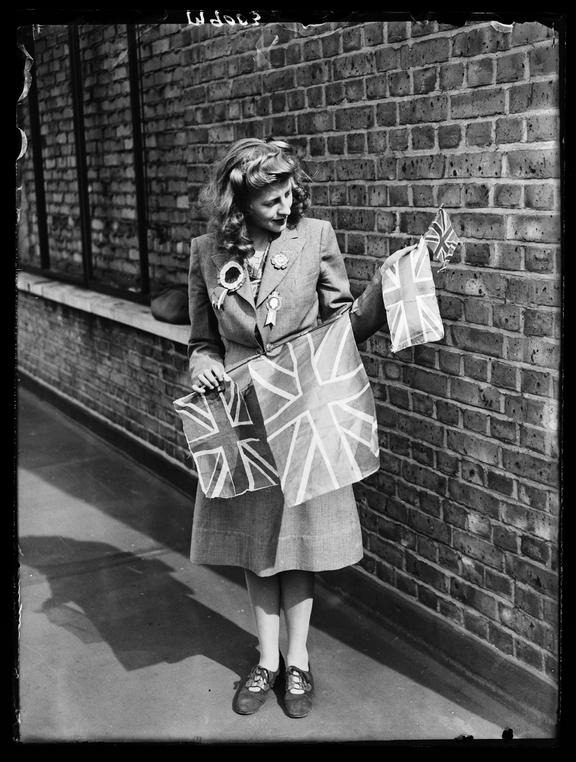 Woman holding Union flags
    A photograph of a woman wearing