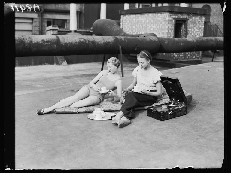 Two women sunbathing
    A photograph of two young women