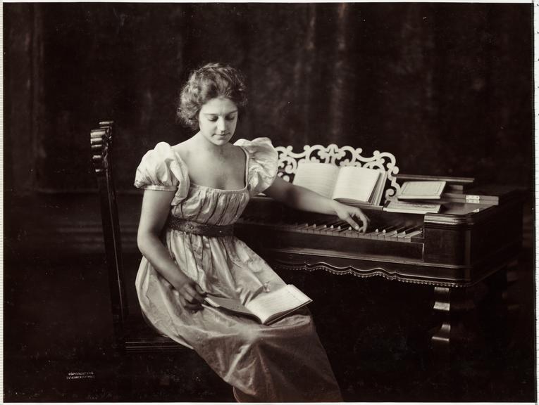 Woman at a piano
    A photograph of a young woman sitting at a