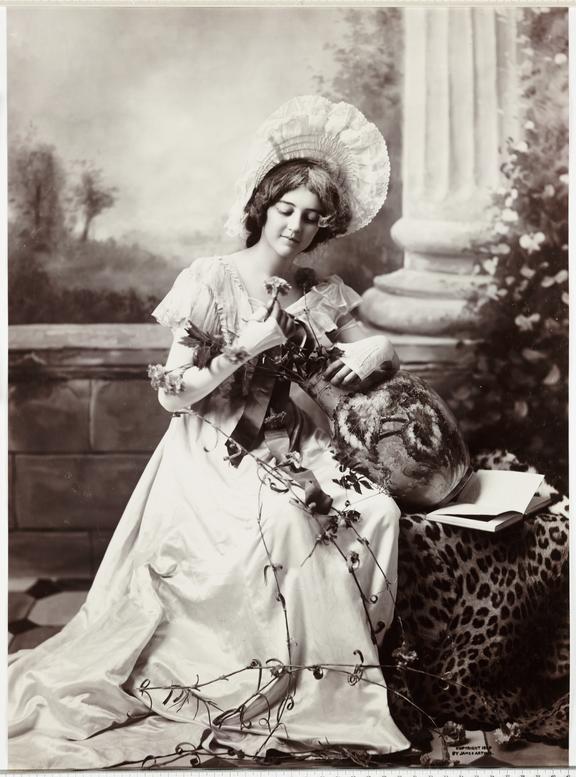 Woman taking flowers from a vase
    A photograph of an