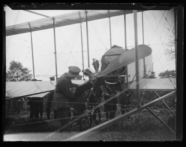 'Pilot Inspecting Aeroplane Propeller'