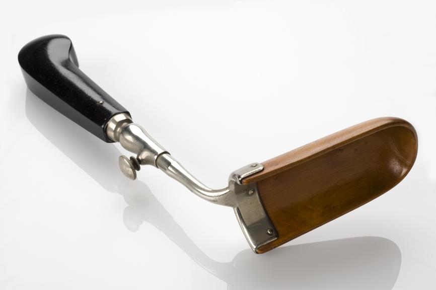 Speculum, vaginal, metal shaft, ebony handle, light wood blade