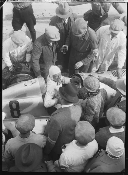 Hanns Geier surrounded by people in his Mercedes-Benz racer