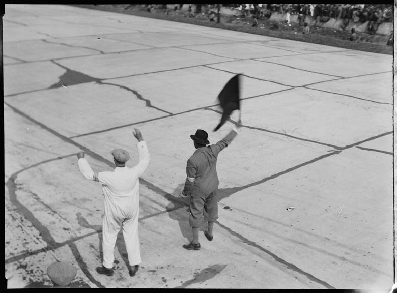 The finish flag being waved on a motor race track, Germany