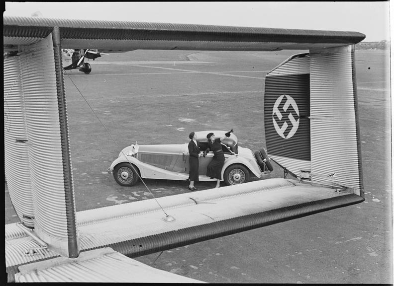 Mercedes-Benz convertible car through tail of Junkers airplane