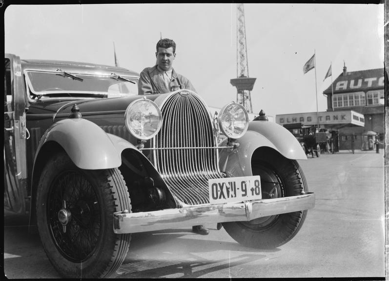 A Bugatti saloon car, with Prince Lobkowicz standing behind