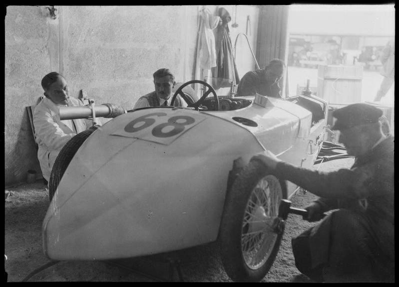 Mechanics in paddock garage with DKW Special racing car