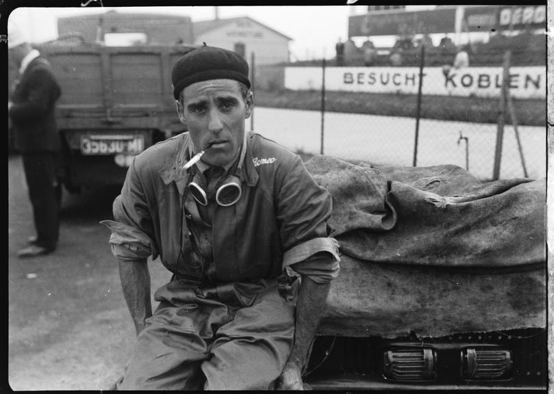 Tazio Nuvolari sits on a covered Alfa Romeo Tipo B Monoposto