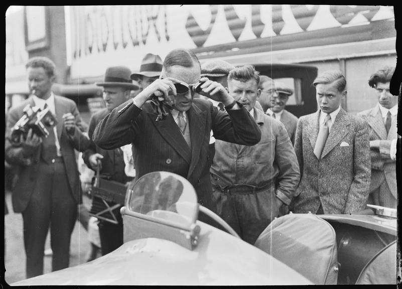 Sir Malcolm Campbell looking at a racing car