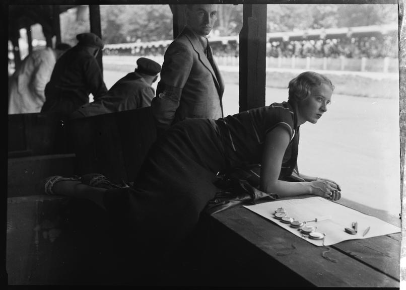 Female timekeeper looks out over AVUS race track, Berlin