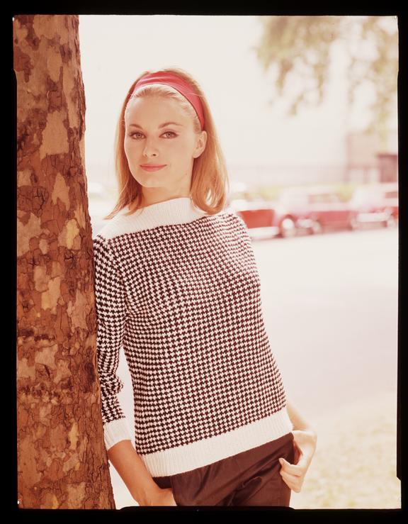 Woman wearing black and white houndstooth knitted jumper